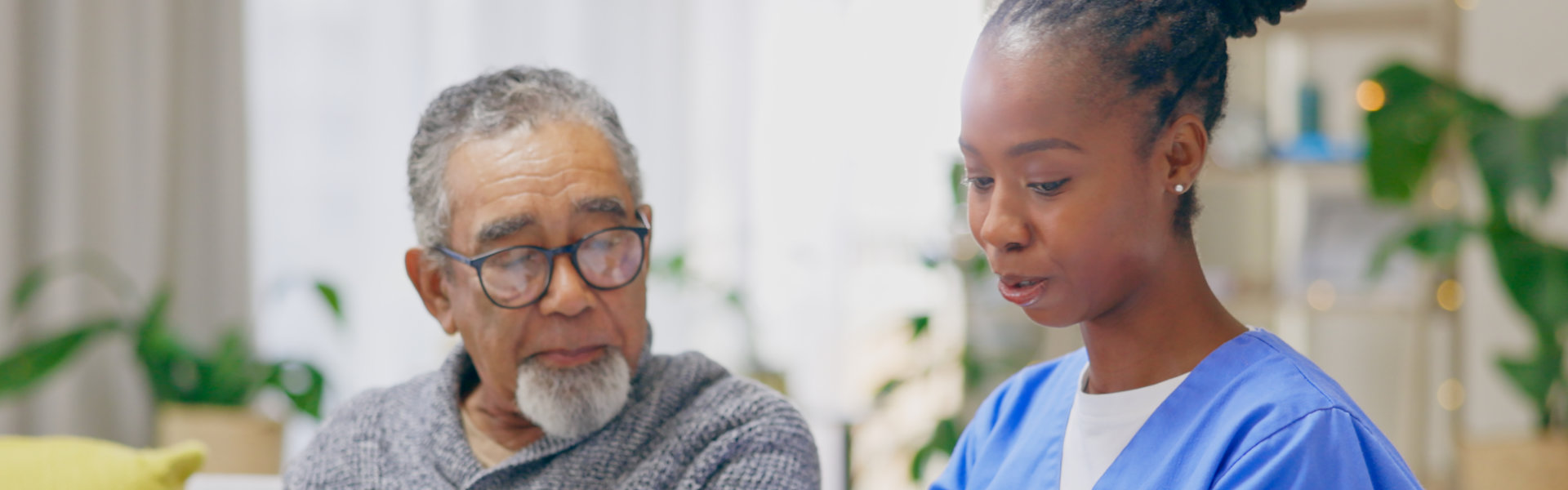 caregiver with senior man with glasses